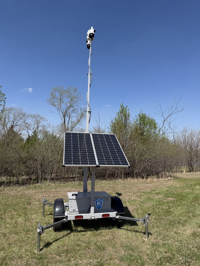 Trailer with solar panel array in an open field